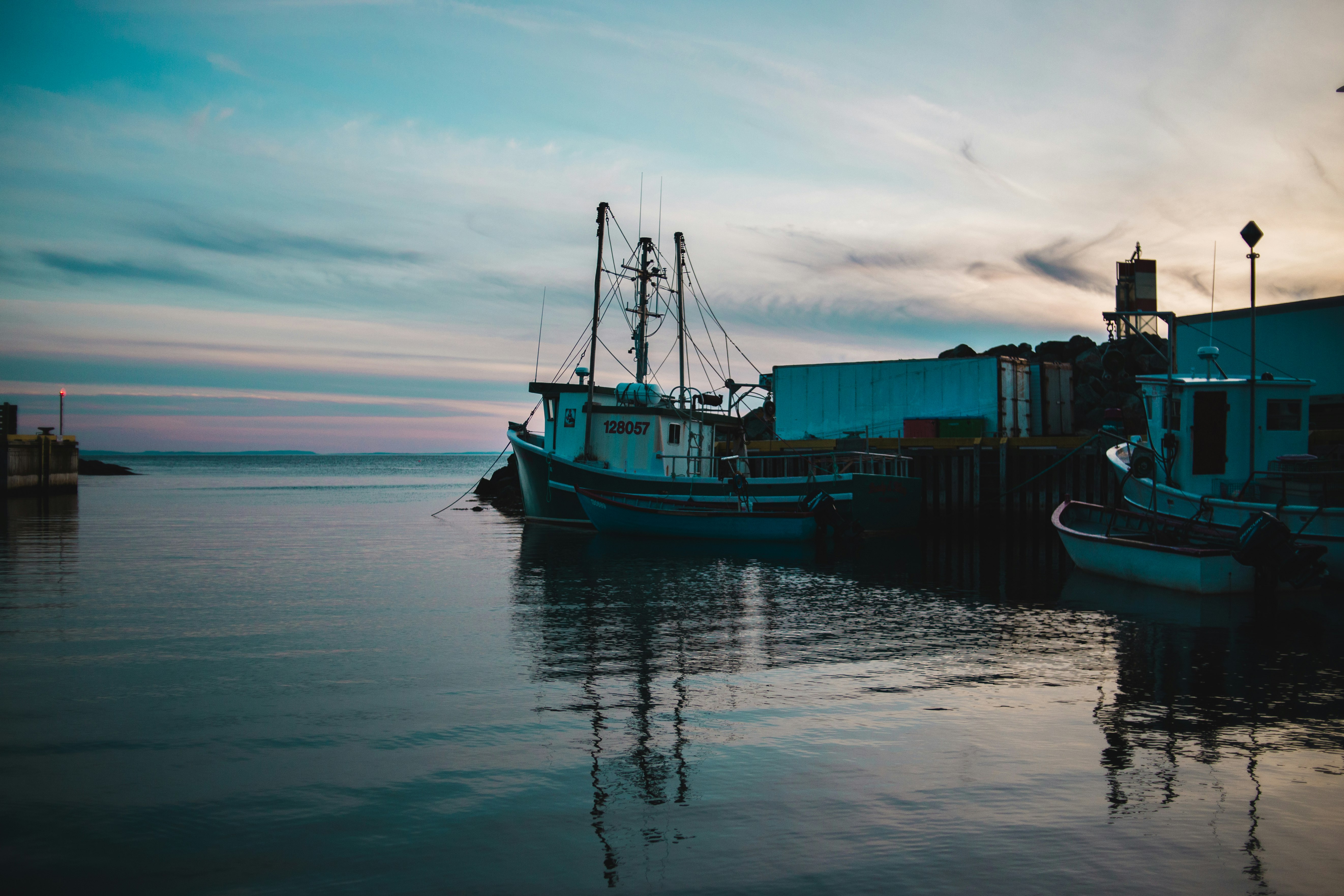 white and gray fishing boat on body of water during daytime